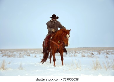 Cowboy Riding A Horse In The Snow