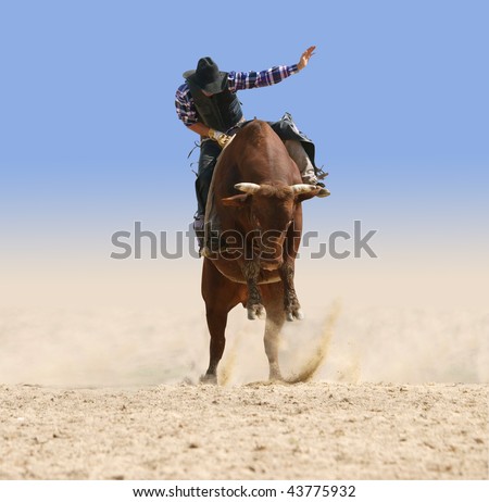 Cowboy Riding a Large Red Bull isolated with clipping path