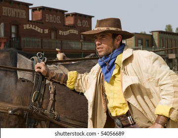 Cowboy standing next to his horse