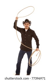 A Cowboy Is Standing With A Rope In His Hand.