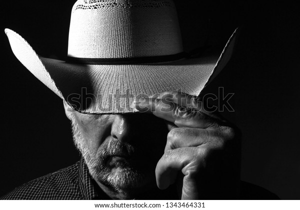 Cowboy Tipping his White\
Hat