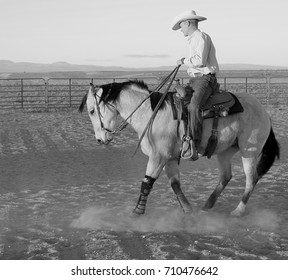 cowboy training horse sunset riding hat saddle  - Shutterstock ID 710476642