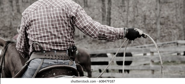 Cowboy In Western Wear On A Horse Using A Rope