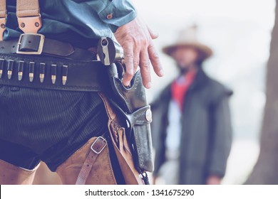 Cowboy.back view of cowboy with gun prepares to gun fight.Conwboy with gun.