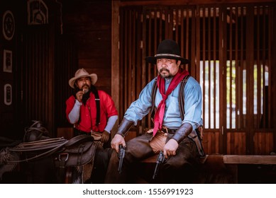 Cowboys Group Caucasian In Country Standing Talking And Hold His Gun On Hand.