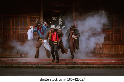 Cowboys group showing action success bank rob with fighting gun and a lot of  money from rob the bank with white smoke vintage style background.