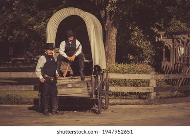 Cowboys Wearing Western Style Suite Talking And Conversation On Horse Cart Is Transportation In 1800s Style. 