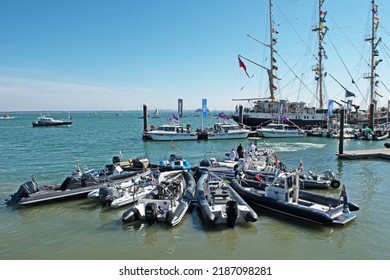 Cowes, United Kingdom - August 6 2022: a group of Zodiac type boats all moored together during Cowes Week.