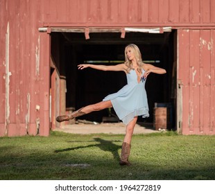 Cowgirl Dancing in front of a red barn