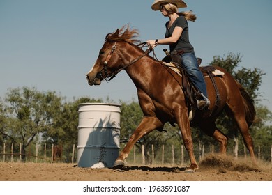 Cowgirl practicing barrel racing for rodeo sport in outdoor arena for western industry with horse.