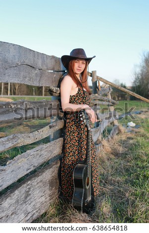 cowgirl un hat with guitar