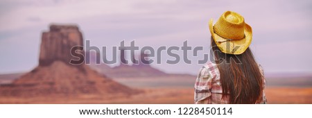 Cowgirl woman enjoying view of Monument Valley in cowboy hat. Beautiful young girl in outdoors, Arizona Utah, USA. Banner panorama.