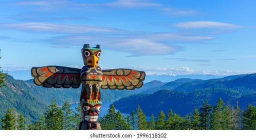 Cowichan Valley, British Columbia  Canada  - June 19, 2021: A First Nations totem pole welcomes travellers at the summit of the Malahat section of the Trans Canada highway near Victoria BC