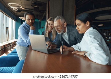 Coworkers discussing biz related problem in the office and using laptop. Conception of business team - Shutterstock ID 2367144757