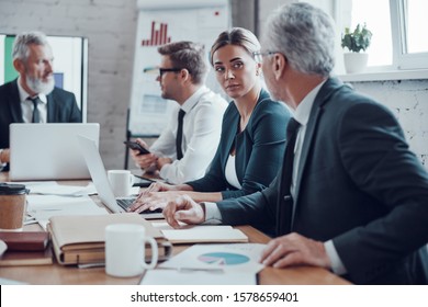 Coworkers discussing new business while working together with colleagues in the modern office - Shutterstock ID 1578659401