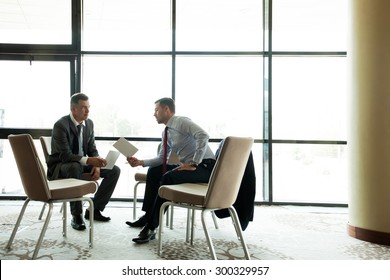 Coworkers discussing project in conference room - Shutterstock ID 300329957