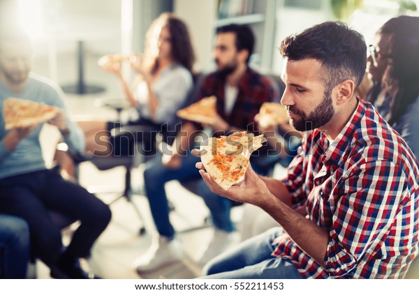 Coworkers Eating Pizza During Work Break Stock Photo Edit Now 552211453