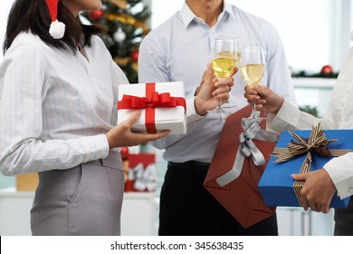 Coworkers Exchanging Christmas Presents At Office Party