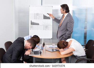 Coworkers Getting Bored At Presentation In The Office - Powered by Shutterstock