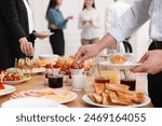 Coworkers having business lunch in restaurant, closeup