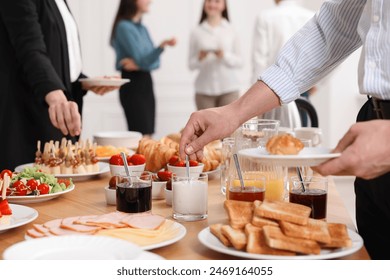 Coworkers having business lunch in restaurant, closeup