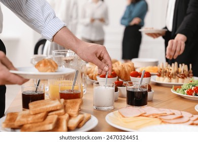 Coworkers having business lunch in restaurant, closeup - Powered by Shutterstock