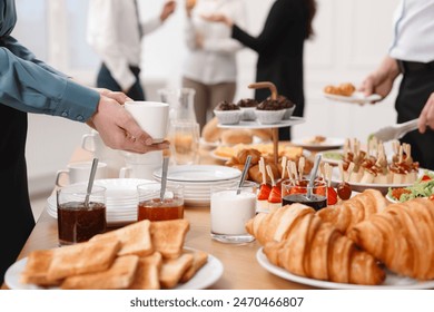 Coworkers having business lunch in restaurant, closeup