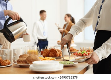 Coworkers having business lunch in restaurant, closeup - Powered by Shutterstock