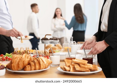 Coworkers having business lunch in restaurant, closeup - Powered by Shutterstock