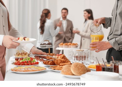 Coworkers having business lunch in restaurant, closeup - Powered by Shutterstock