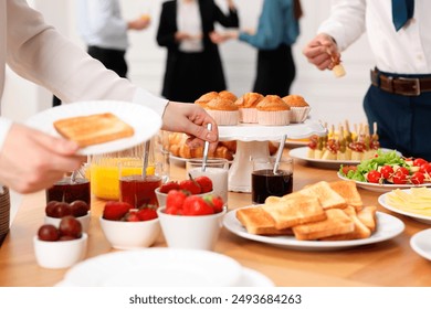 Coworkers having business lunch in restaurant, closeup - Powered by Shutterstock