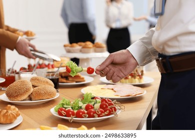 Coworkers having business lunch in restaurant, closeup - Powered by Shutterstock