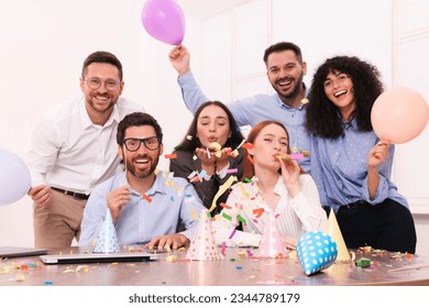 Coworkers having fun during office party indoors - Powered by Shutterstock