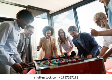 Coworkers playing table football on break from work