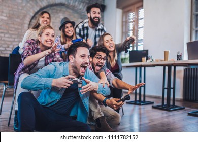 Coworkers Playing Video Games In Office.