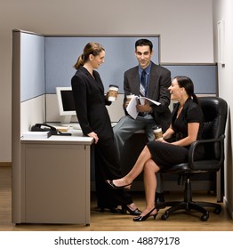 Co-workers Talking In Office Cubicle