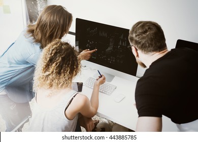 Coworkers Team Working Loft Office Startup.Business Crew work Modern Desktop Monitor Wood Table.Bank Managers Market Researching Process.Virtual Digital Diagram Interface Screen.Analyze stocks.Blurred