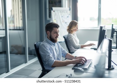 Coworkers working on a computer in the office. - Shutterstock ID 511238431