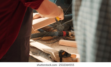 Coworking artisans in studio using sandpaper and wood shaper for sanding wooden surface. Carpenter and african american apprentice wearing safety glasses polishing lumber pieces, camera A - Powered by Shutterstock