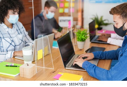 Coworking office and multiracial staff wearing protective face masks for coronavirus - Workplaces and safety measures - Focus on the hand of the man - Shutterstock ID 1833473215