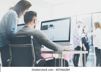 Coworking process, designers team working modern office.Photo young creative manager showing new startup idea monitor. Desktop computers on wood table. Blurred background, film effect. Horizontal - Shutterstock ID 407666284