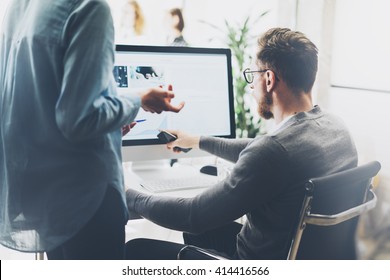 Coworking process,managers team work new project.Photo young business crew working with startup modern office.Desktop computer on table,pictures screen monitor. Blurred,film effect. Horizontal - Powered by Shutterstock