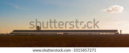 Cowsheds, farm and silo with a field in the foreground. Southern Russia. The Volga-Don