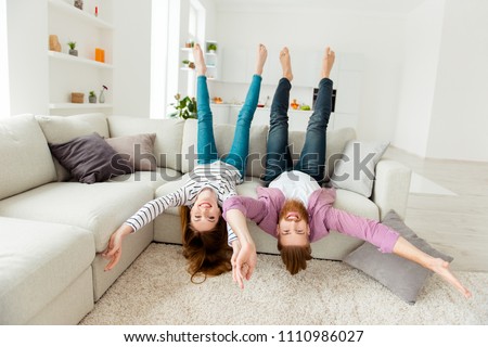 Coziness holiday house friendship funny partners lifestyle leisure concept. Excited cheerful joyful funky rejoicing lovers fooling around lying on divan in living room wearing casual outfit clothes