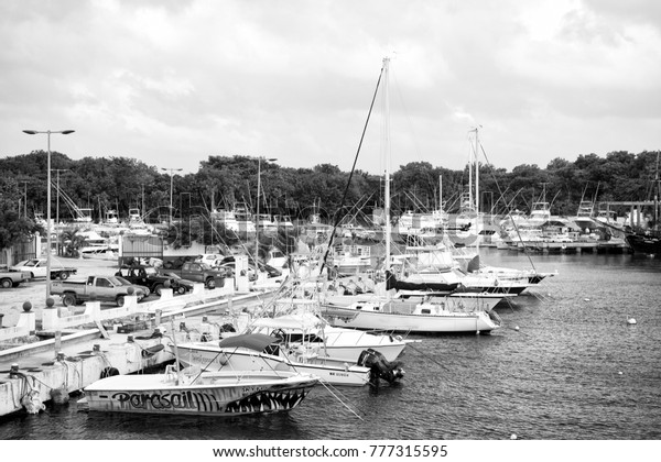 Cozumel, Mexico -
December 24, 2015: yacht, boat, ship transportation in bay or
harbor with sea, ocean water and cloudy sky sunny near parking car.
traveling and vacation,
yachting