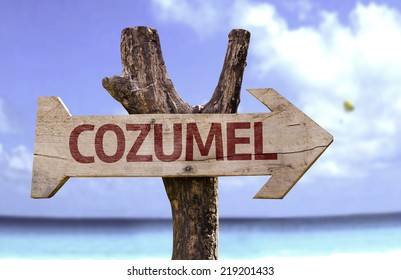 Cozumel Wooden Sign With A Beach On Background