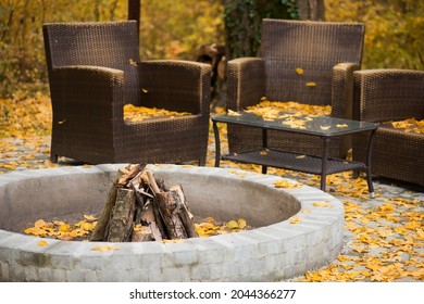 Cozy Autumn Patio With Chairs, Hearth And Fire Woods. Exterior In Backyard For Relax In Autumn Garden. Fall Decor. Selective Focus.