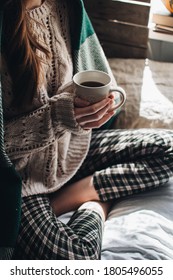 Cozy Autumn Or Winter Atmosphere. Young Woman With Cup Of Tea And Warm Sweater Is Seating At Home Near The Window. Scandinavian Hygge Concept.