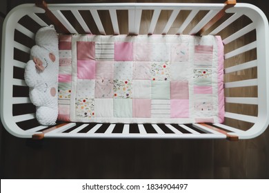 Cozy Baby Cot With Pink Patchwork Blanket. Baby Bedding. Baby Crib, Close Up. Bedding And Textile For Children Nursery. Nap And Sleep Time.