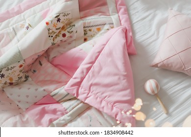 Cozy Baby Cot With Pink Patchwork Blanket. Baby Bedding. Baby Crib, Close Up. Bedding And Textile For Children Nursery. Nap And Sleep Time.